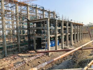 Pipeline corridor construction with multiple cranes and large equipment.