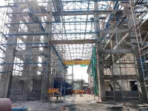 Interior of the pump house under assembly with large structural steel members.