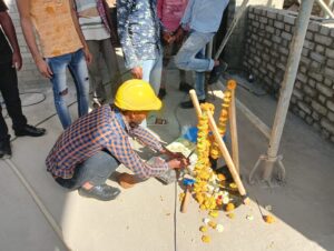 Religious ceremony with workers performing traditional rituals on-site.